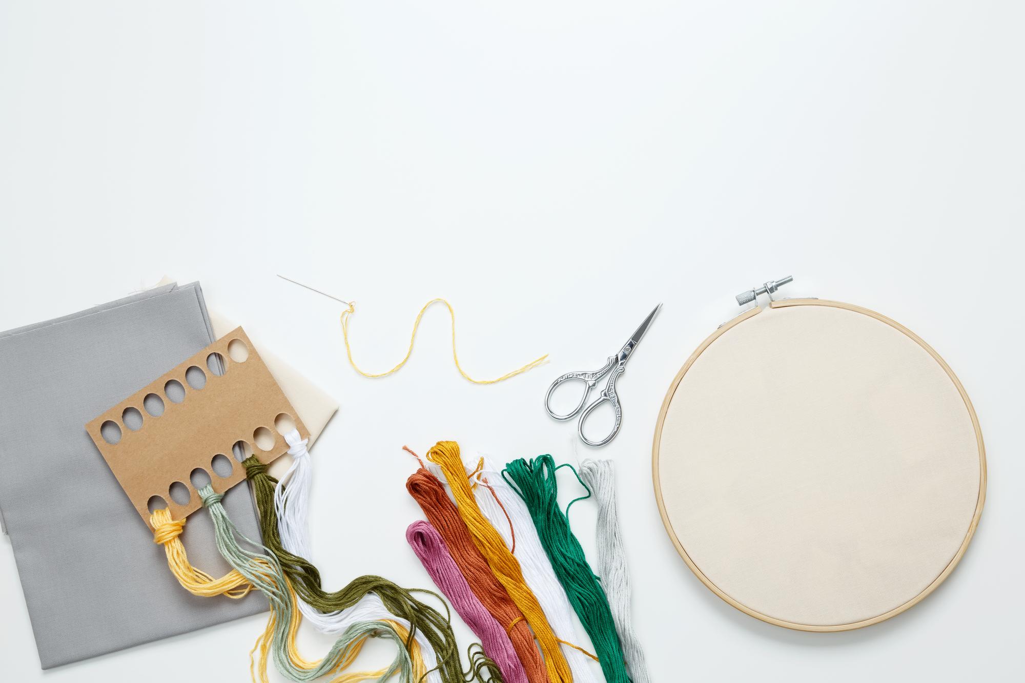 selection of embroidery threads and tools